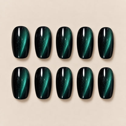 Elevate your look with these mesmerizing dark green cat eye almond press-on nails. The striking cat-eye effect shifts beautifully with light, creating a deep, mysterious emerald glow. Perfect for date nights, evening outings and special occasions.
