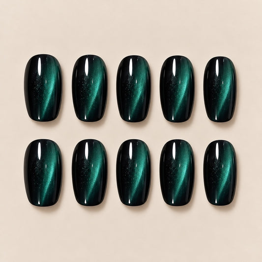 Elevate your look with these mesmerizing dark green cat eye almond press-on nails. The striking cat-eye effect shifts beautifully with light, creating a deep, mysterious emerald glow. Perfect for date nights, evening outings and special occasions.