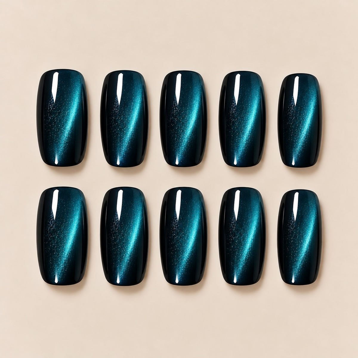 These stunning peacock teal cat eye almond press-on nails feature a magical shifting cat-eye streak, blending deep blue and emerald tones for a cool, eye-catching finish. Perfect for evening looks, parties and night-out styling.