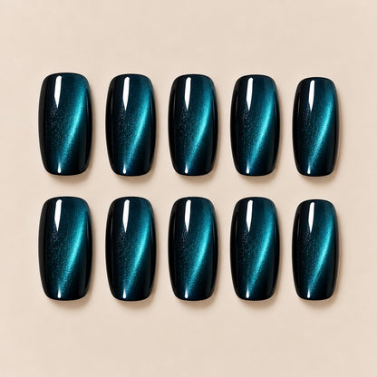 These stunning peacock teal cat eye almond press-on nails feature a magical shifting cat-eye streak, blending deep blue and emerald tones for a cool, eye-catching finish. Perfect for evening looks, parties and night-out styling.