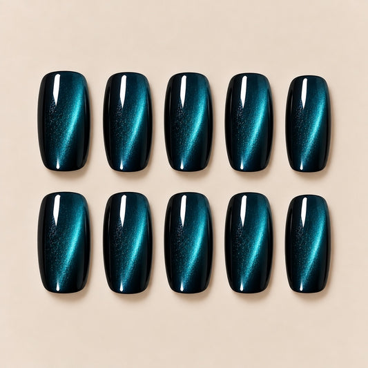 These stunning peacock teal cat eye almond press-on nails feature a magical shifting cat-eye streak, blending deep blue and emerald tones for a cool, eye-catching finish. Perfect for evening looks, parties and night-out styling.