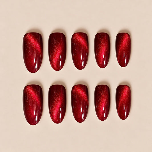 Our stunning red glass cat eye almond press-on nails bring a sophisticated, glamorous look. The rich ruby red cat eye finish creates a shiny light streak across each nail, perfect for date nights, parties, holiday & evening looks.